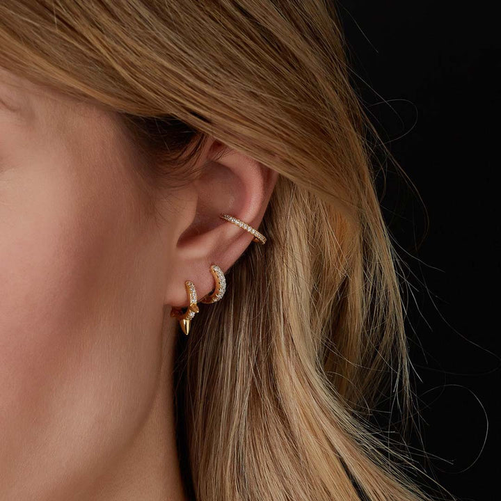 model wearing gold plated huggie earrings