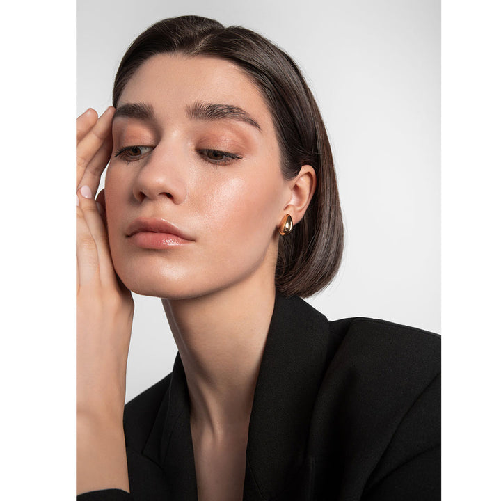 gold plated chunky tear drop earrings on model