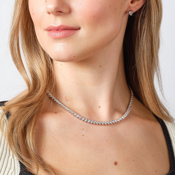 Silver heart shaped cz stud earrings on model