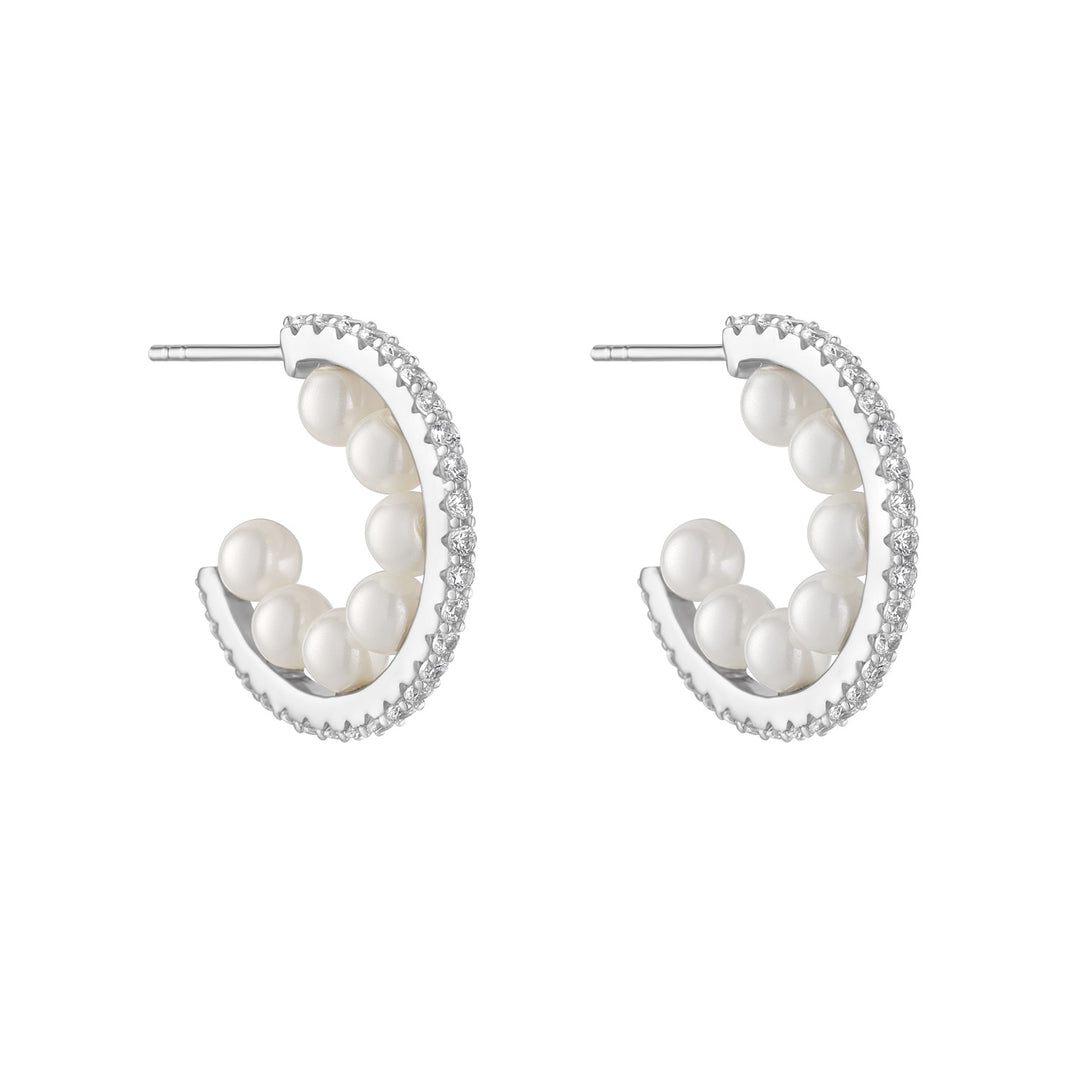 silver cubic zirconia inside pearl hoop earrings on white background