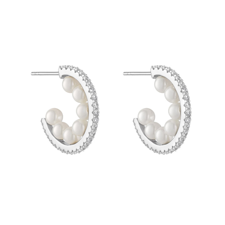 silver cubic zirconia inside pearl hoop earrings on white background