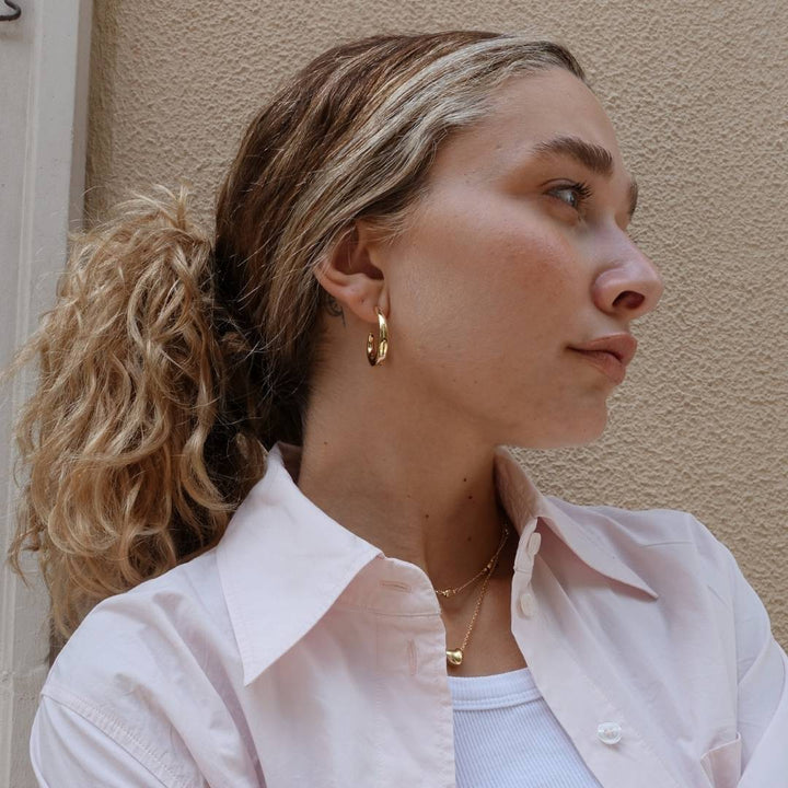 gold plated hoop earrings on model
