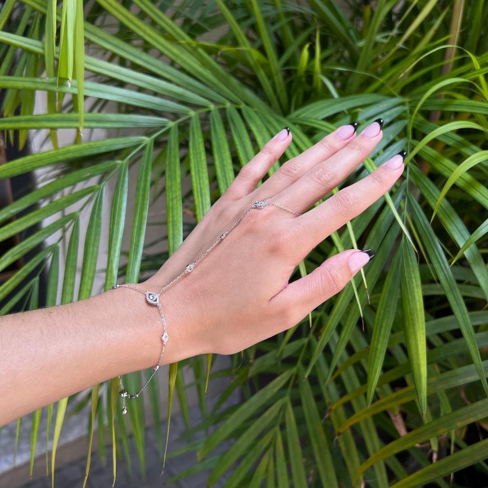 model wearing sterling silver evil eye hand chain bracelet