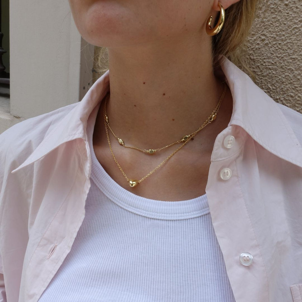 gold plated layered necklaces on model
