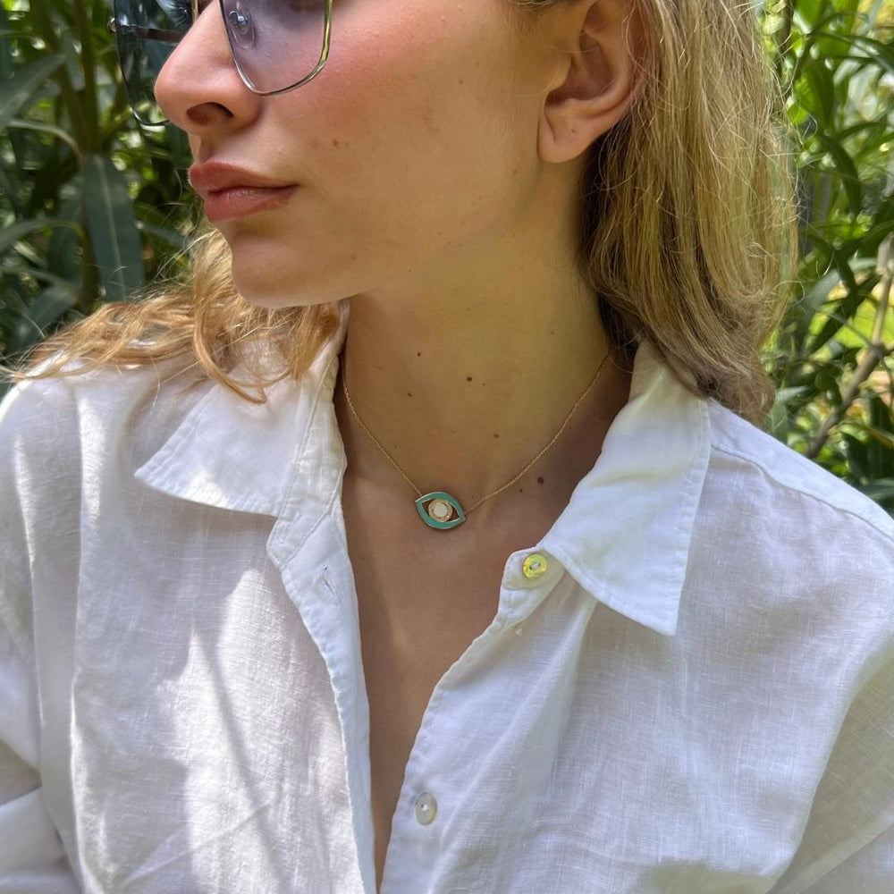 gold plated blue evil eye necklace on model