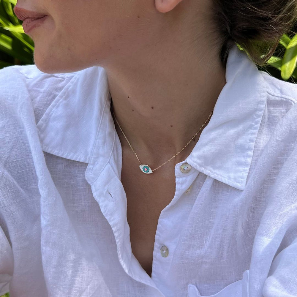 model wearing gold plated white evil eye necklace