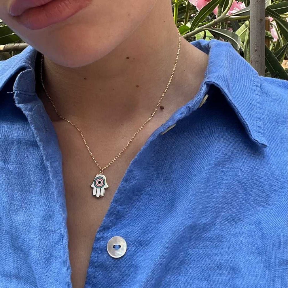 model wearing gold plated white hand of fatima necklace