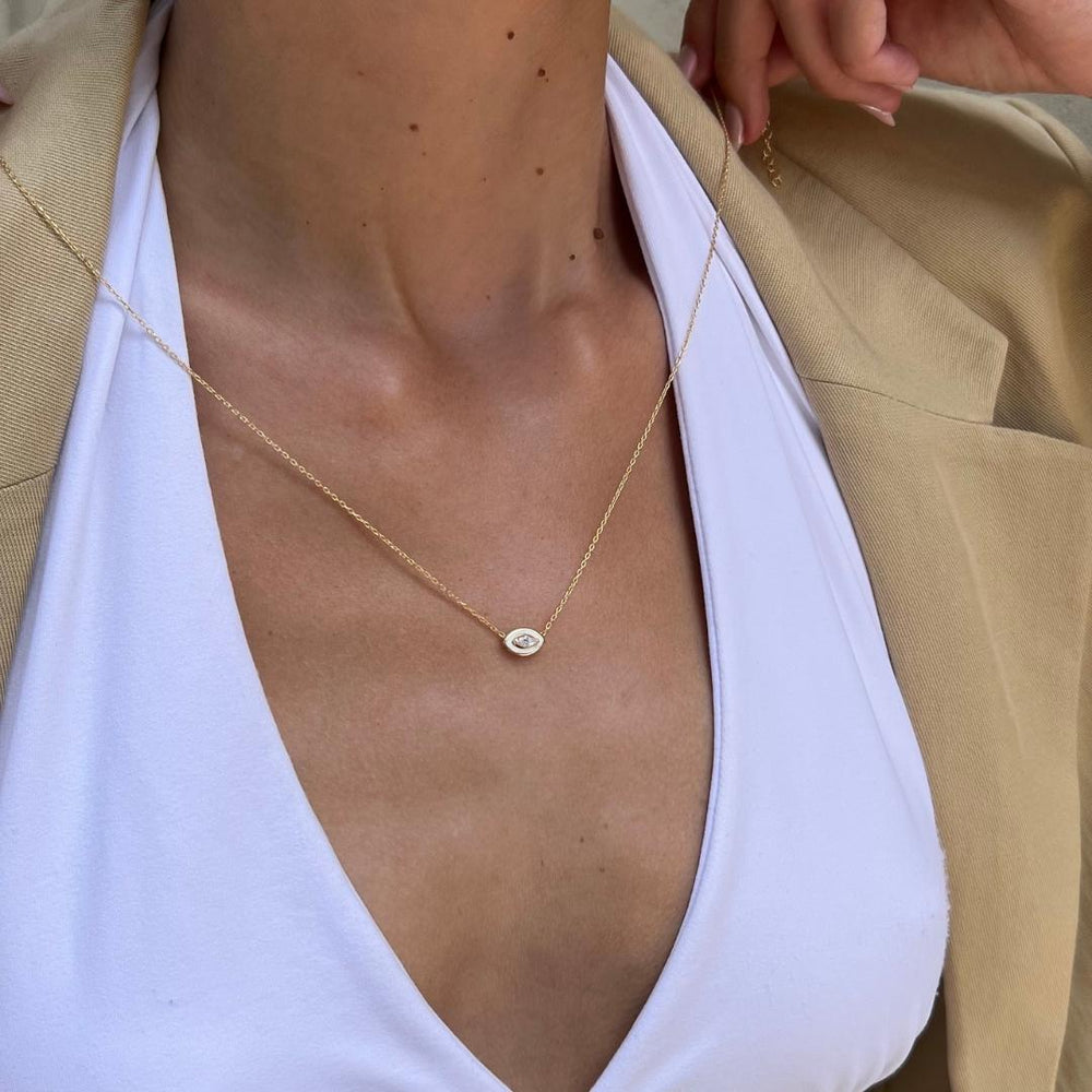 gold plated white evil eye necklace on model