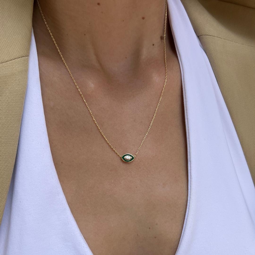 gold plated green evil eye necklace on model