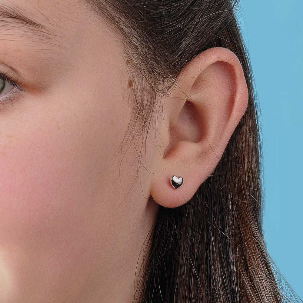 model wearing sterling silver heart stud earrings
