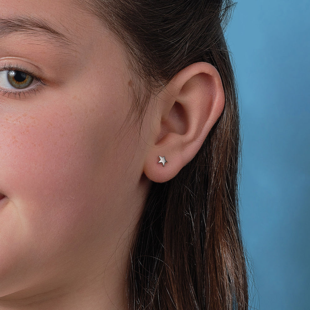 model wearing silver star stud earings