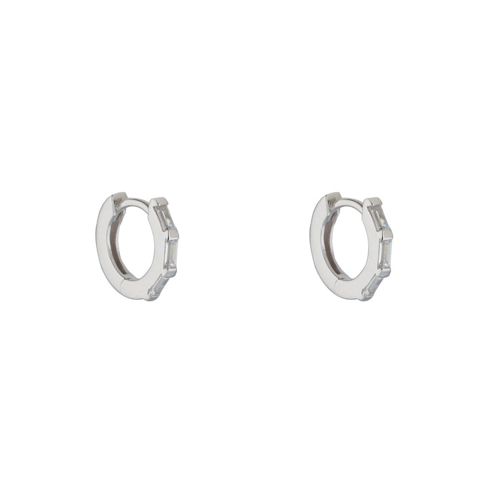 silver cubic baguette huggie earrings on white background