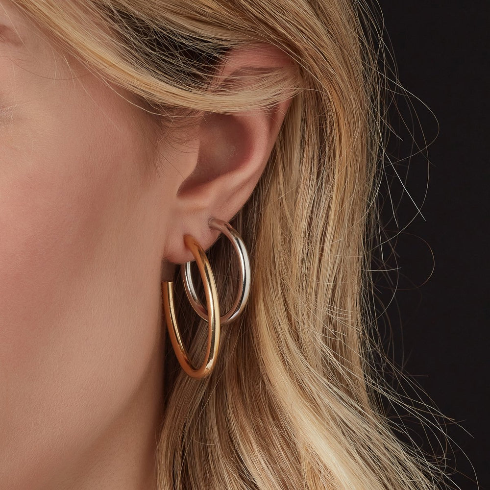 silver hoop earrings and gold plated hoop earrings on model