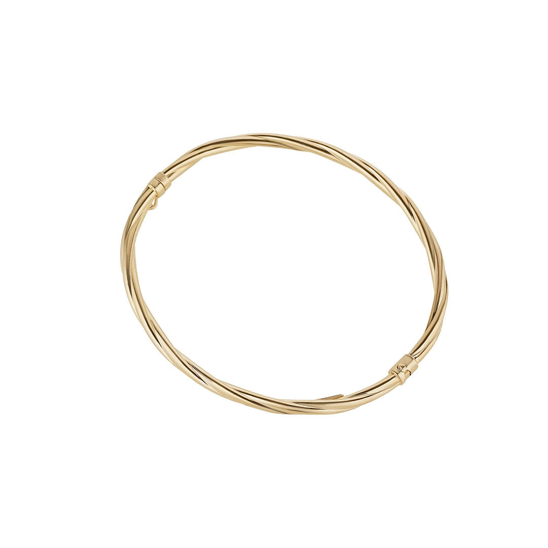 gold plated twist bangle on white background