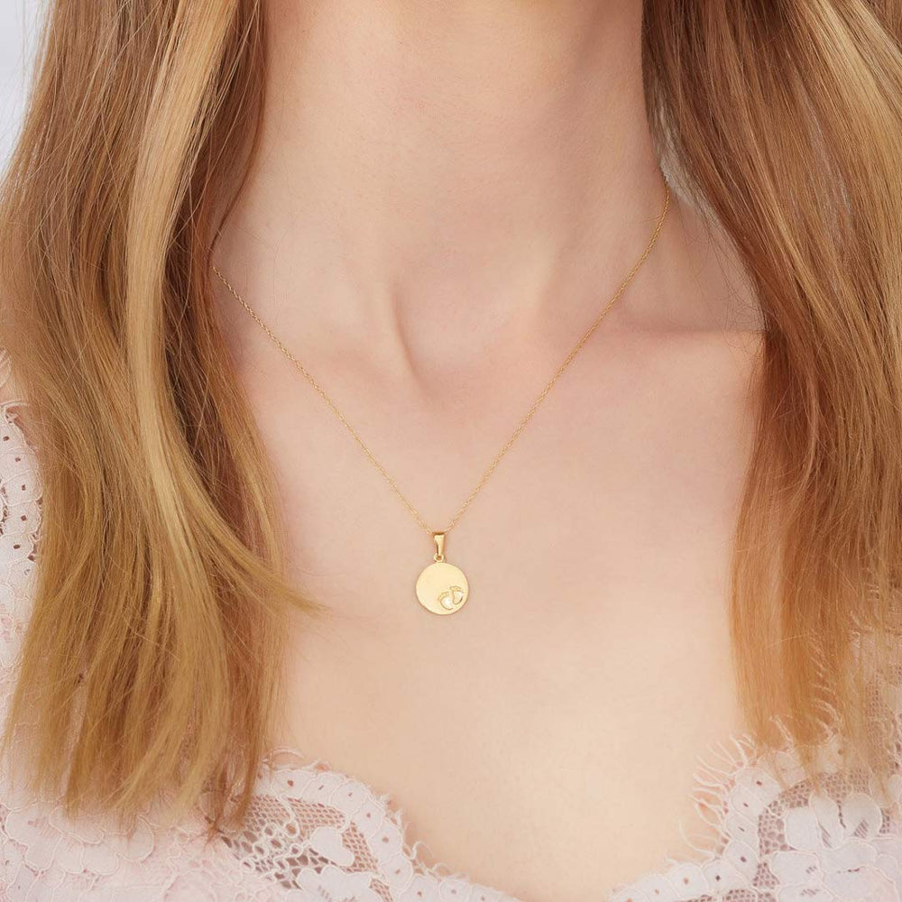 Model wearing  9ct gold baby footprint necklace from NJO Designs