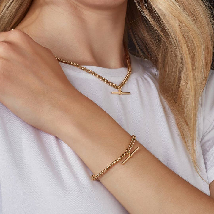 gold t-bar necklace and bracelet on a model