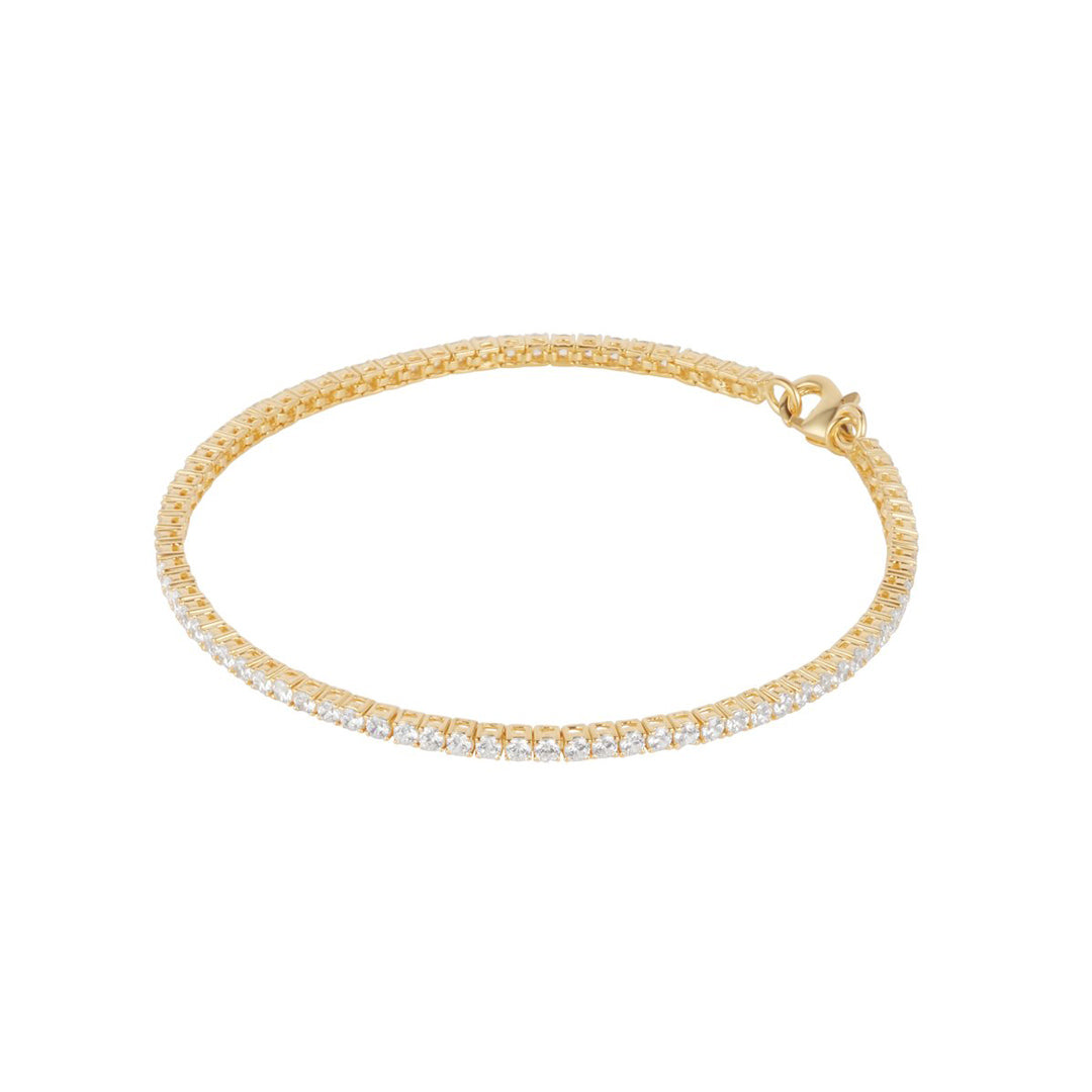 gold plated claw set tennis bracelet on white background