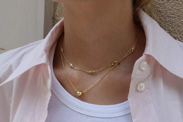 gold plated necklaces on a model