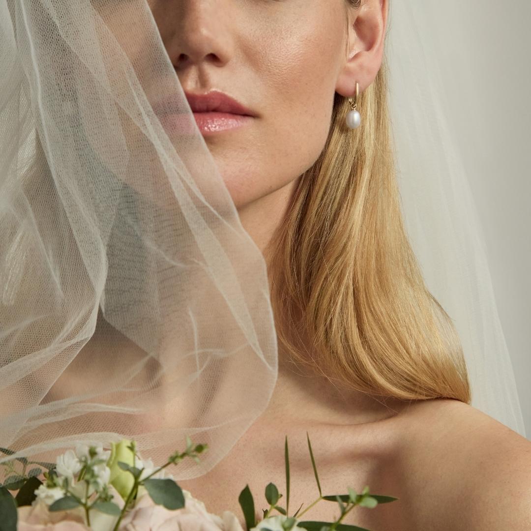 9ct gold pearl drop huggie earrings on bride