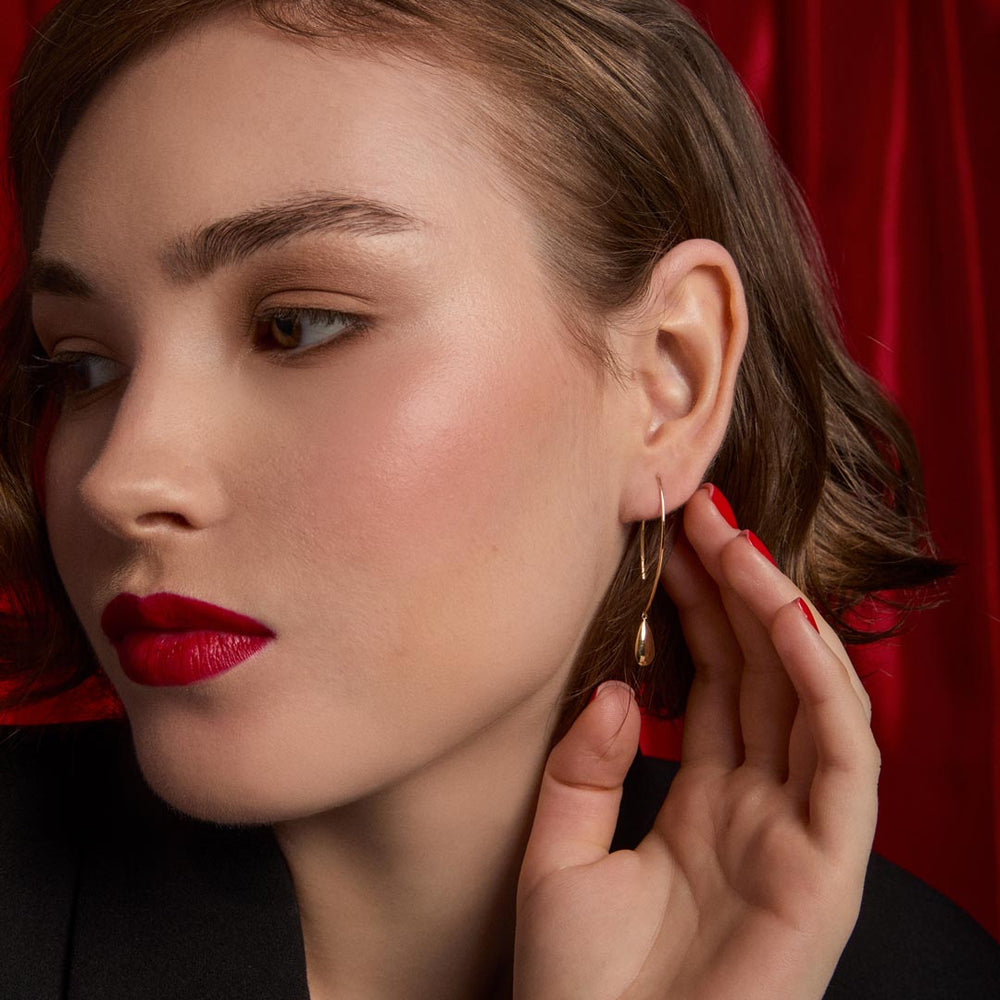 9ct gold teardrop hoop drop earrings on model