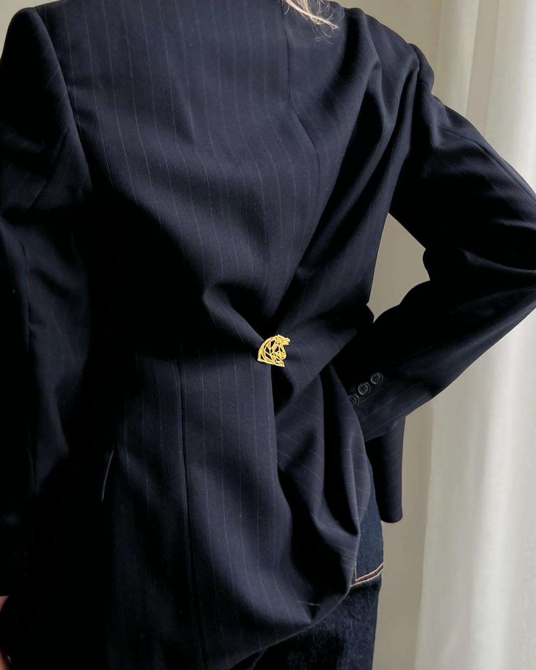 model wearing gold plated horse brooch