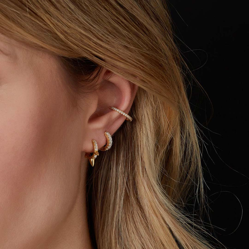 model wearing gold plated huggie earrings