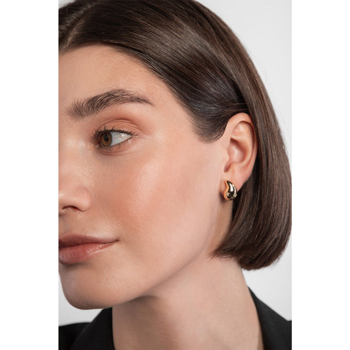 gold plated teardrop stud earrings on model
