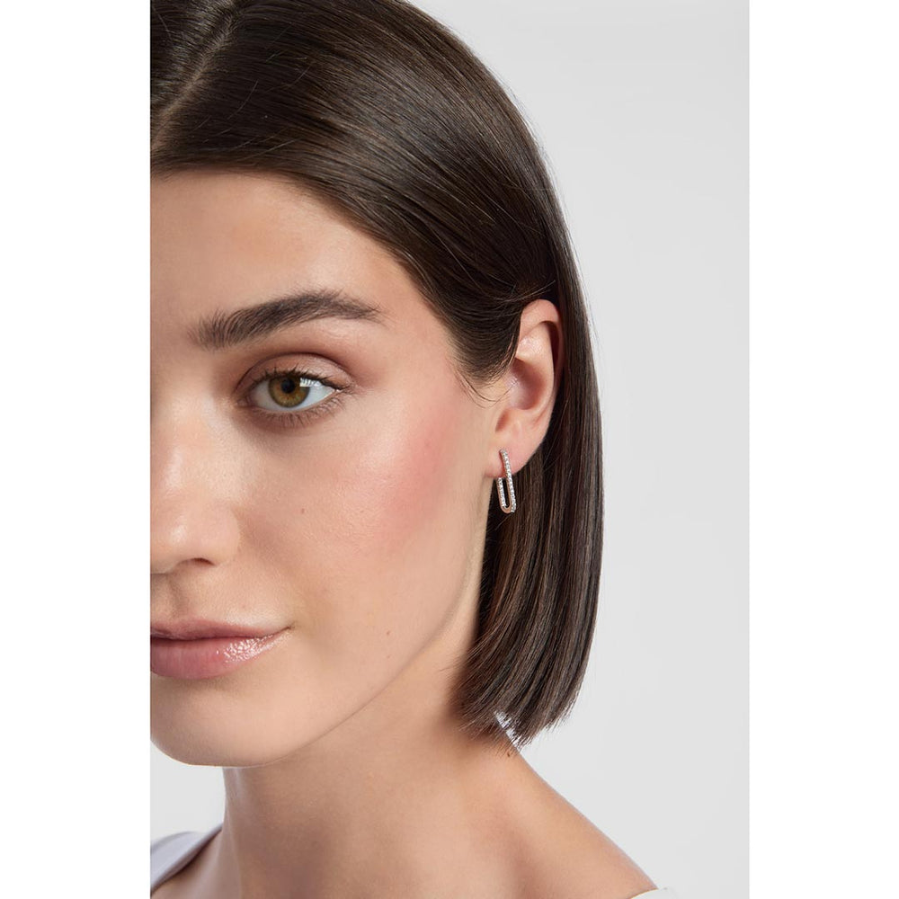 model wearing silver rectangle hoops