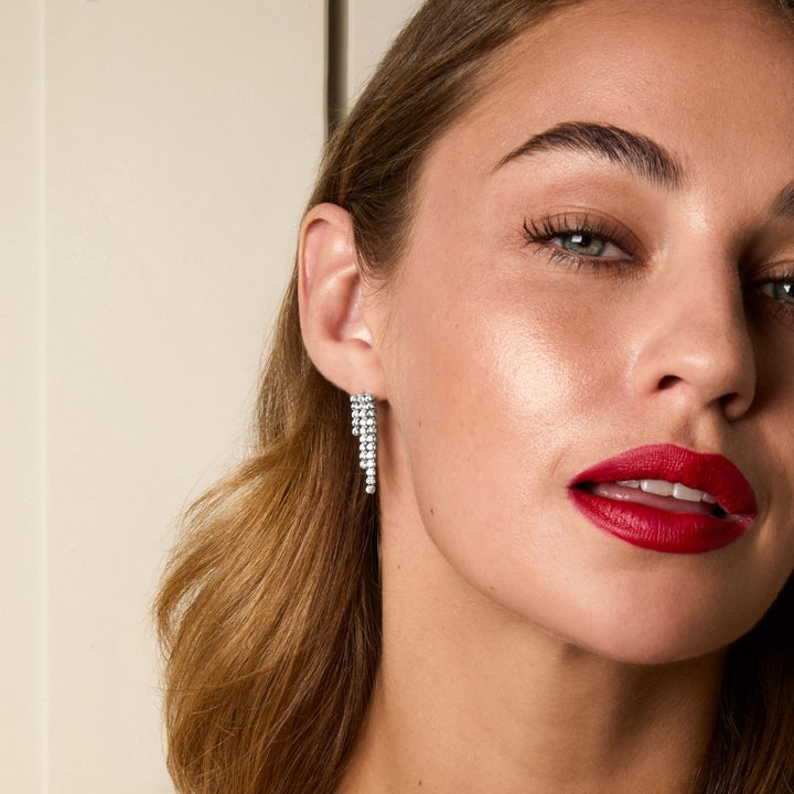sterling silver tennis drop earrings on model