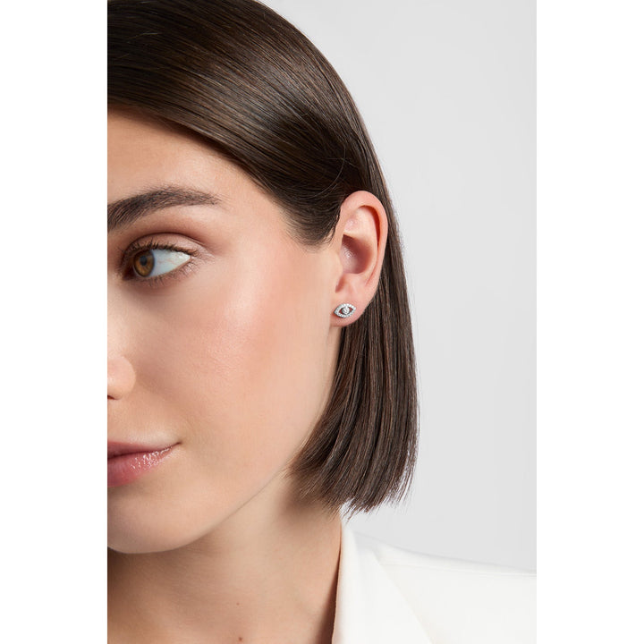 model wearing silver evil eye stud earrings