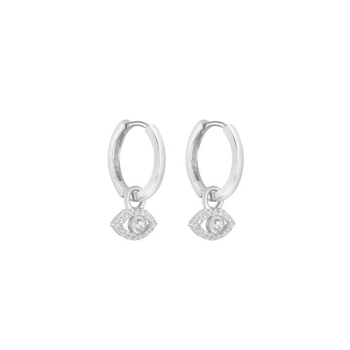 silver evil eye cz huggie earrings on white background
