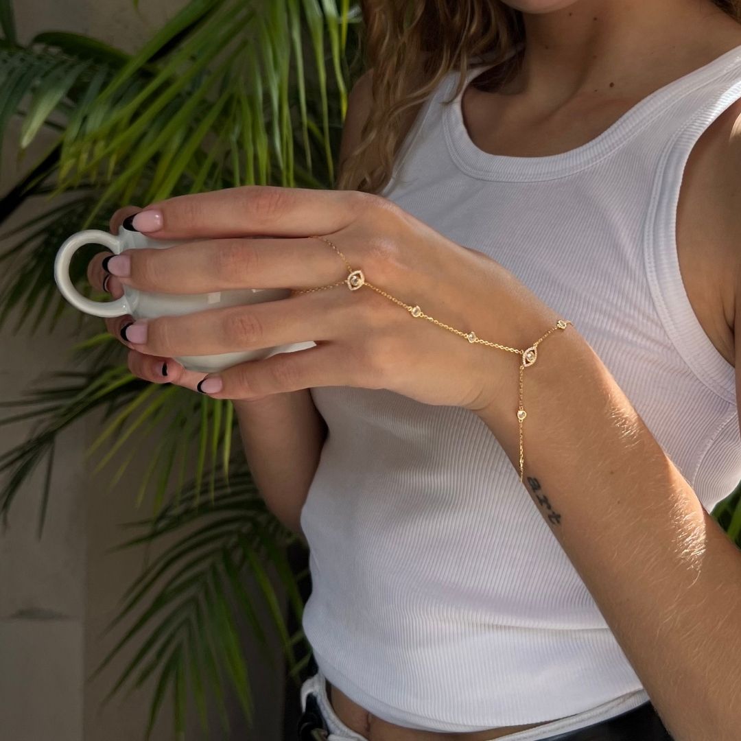 gold plated evil eye hand chain bracelet