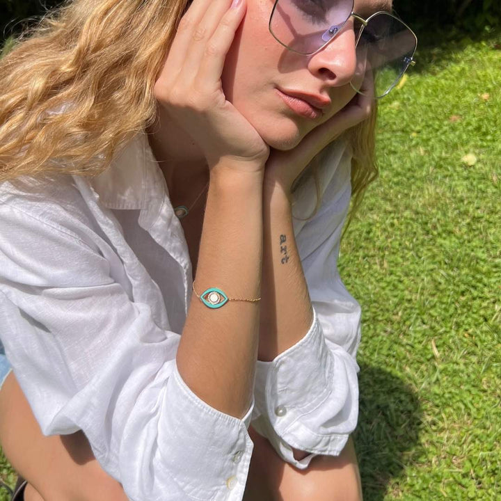 model wearing gold plated blue evil eye bracelet