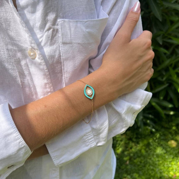 model wearing gold plated blue evil eye bracelet