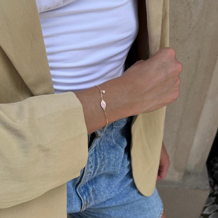 model wearing gold plated pink cz charm evil eye bracelet