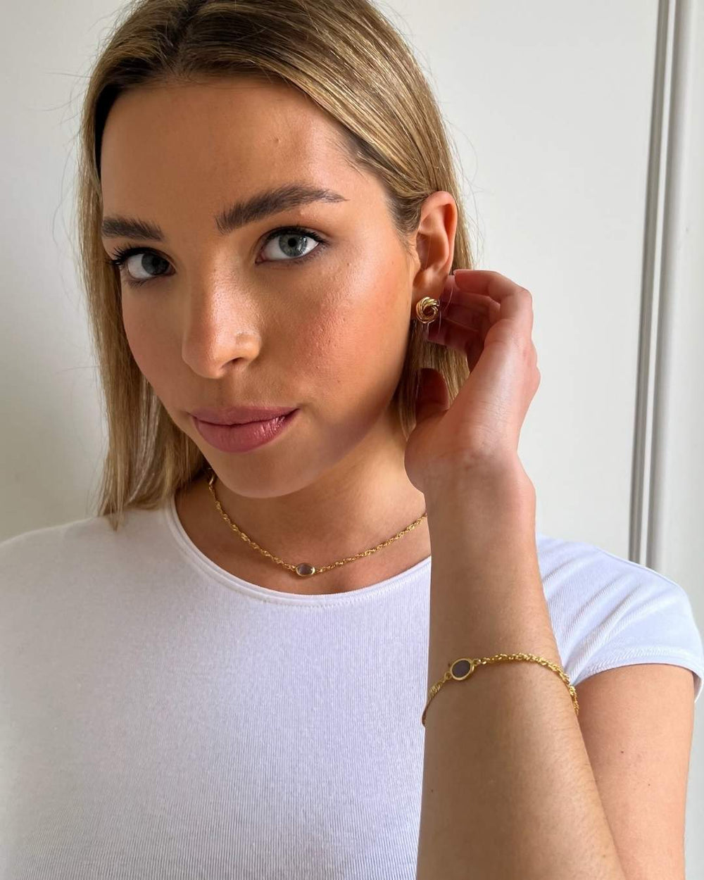 model wearing gold lavender oval bracelet and necklace