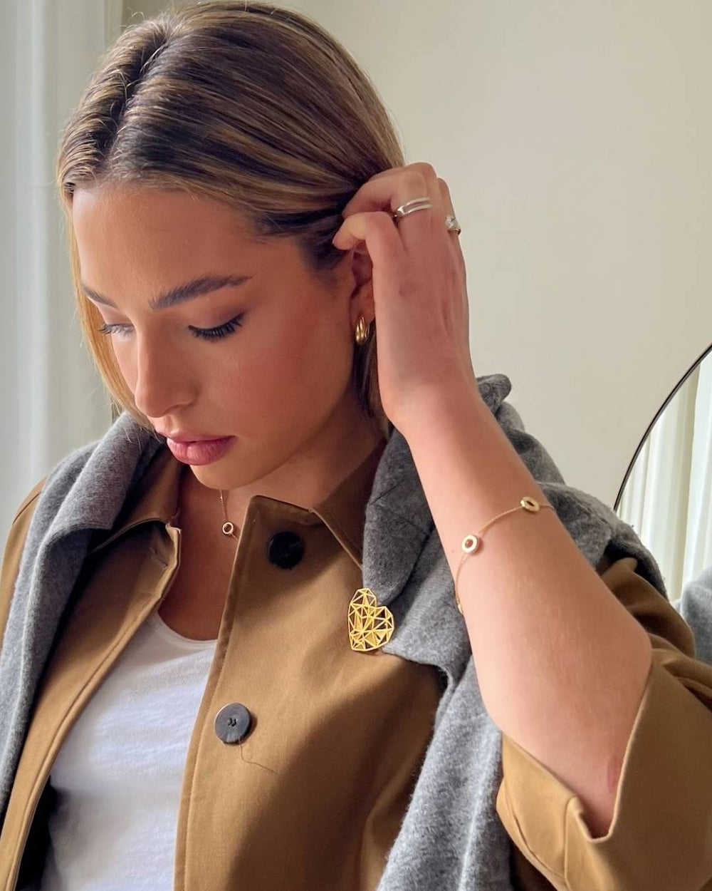 model wearing gold circle necklace and bracelet