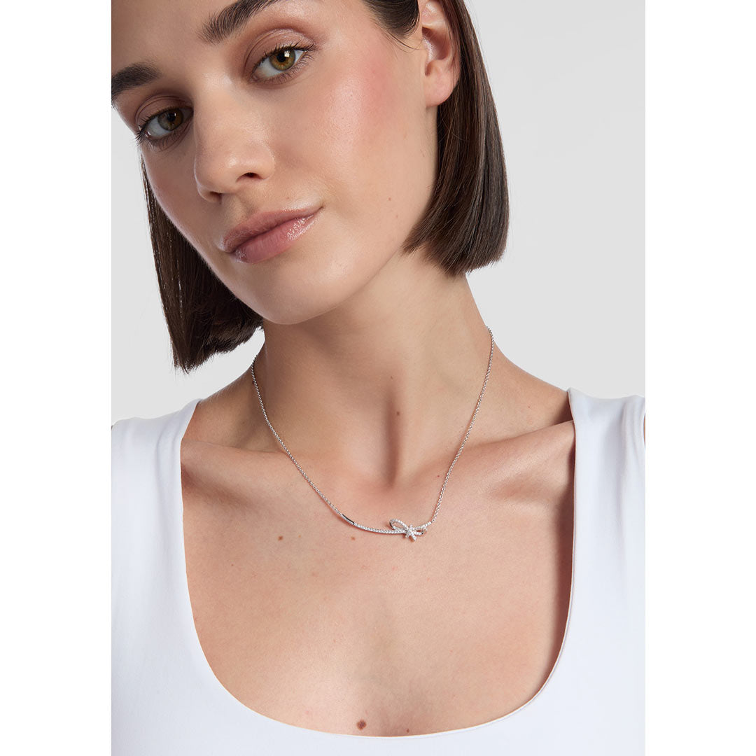 model wearing silver bow necklace