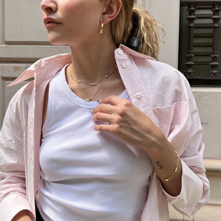 gold plated layered jewellery on model