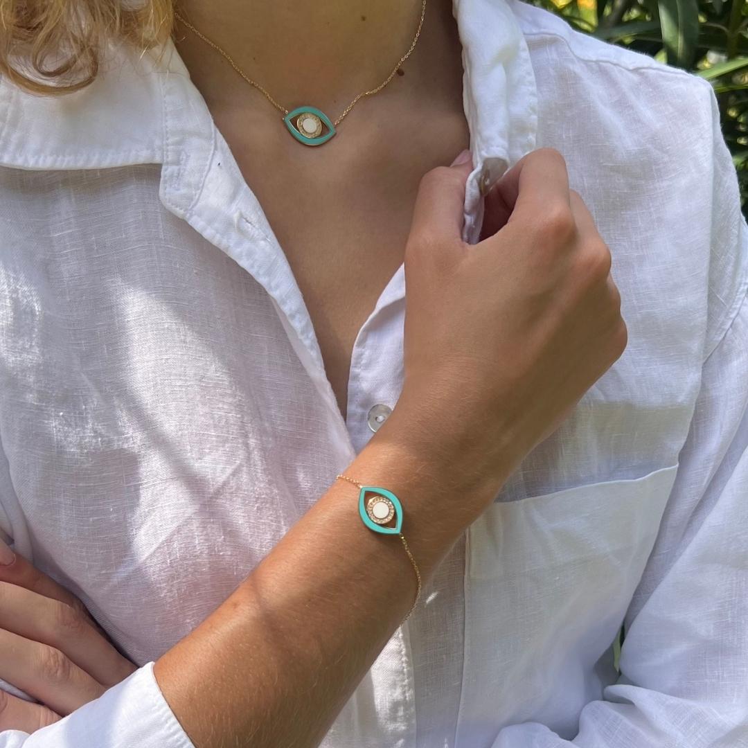 gold plated blue evil eye jewellery on model