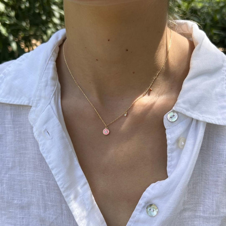 model wearing gold plated pink evil eye cz charm necklace