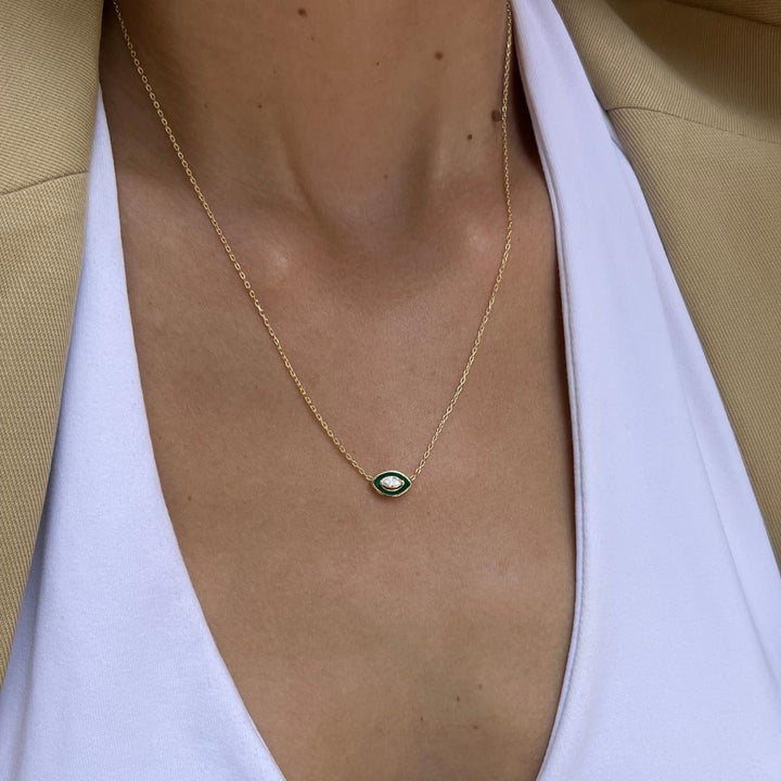 gold plated green evil eye necklace on model