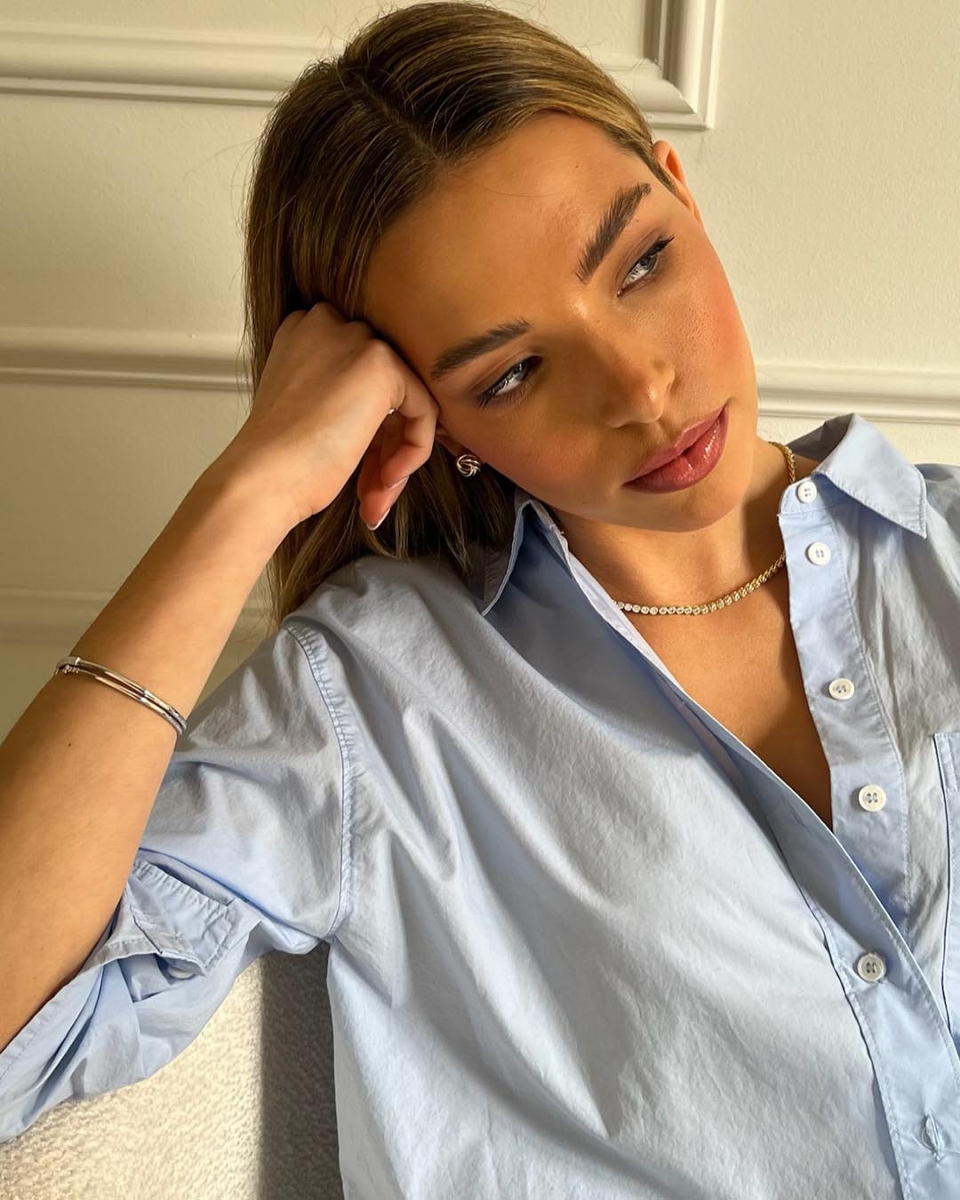 model wearing gold tennis necklace and silver bracelets