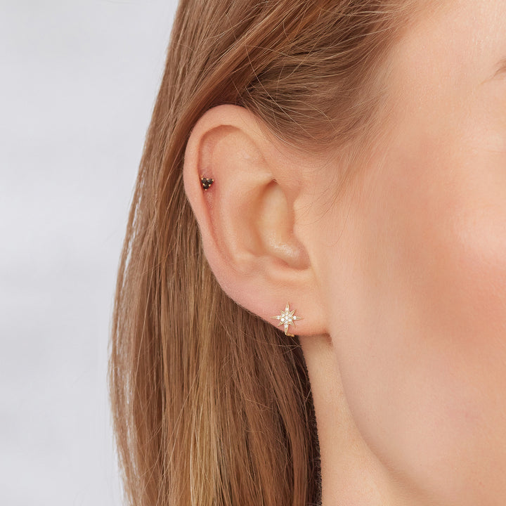 9ct gold trinity piercing earring on model
