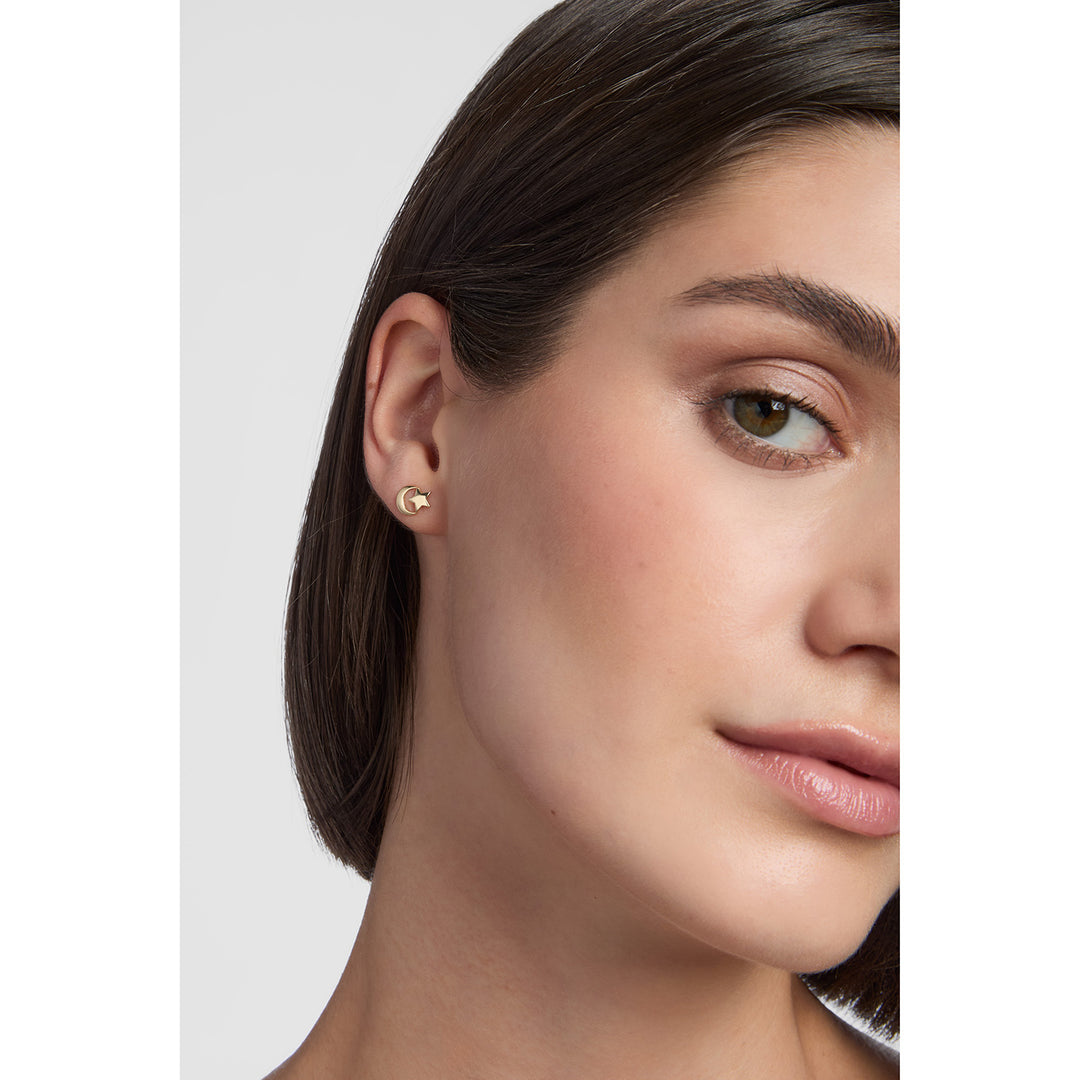 model wearing 9ct gold moon and star stud earrings