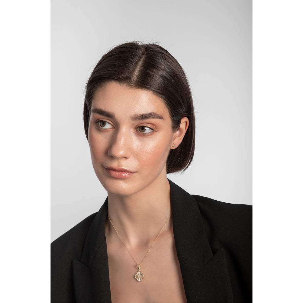 Model wearing 9ct gold flower stud earring with cubic zirconia centre
