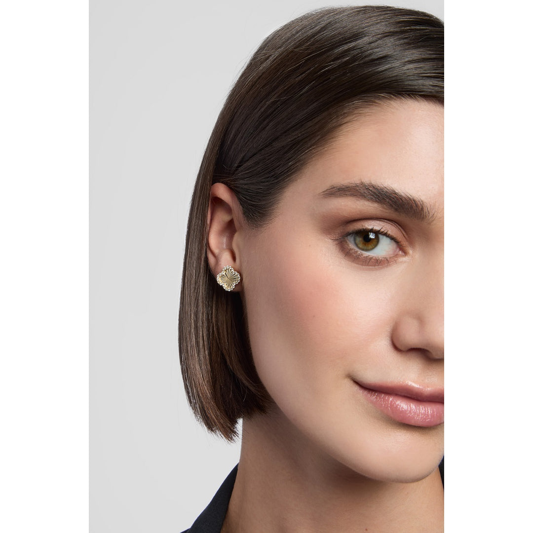 model wearing 9ct gold clover stud earring with cubic zirconia