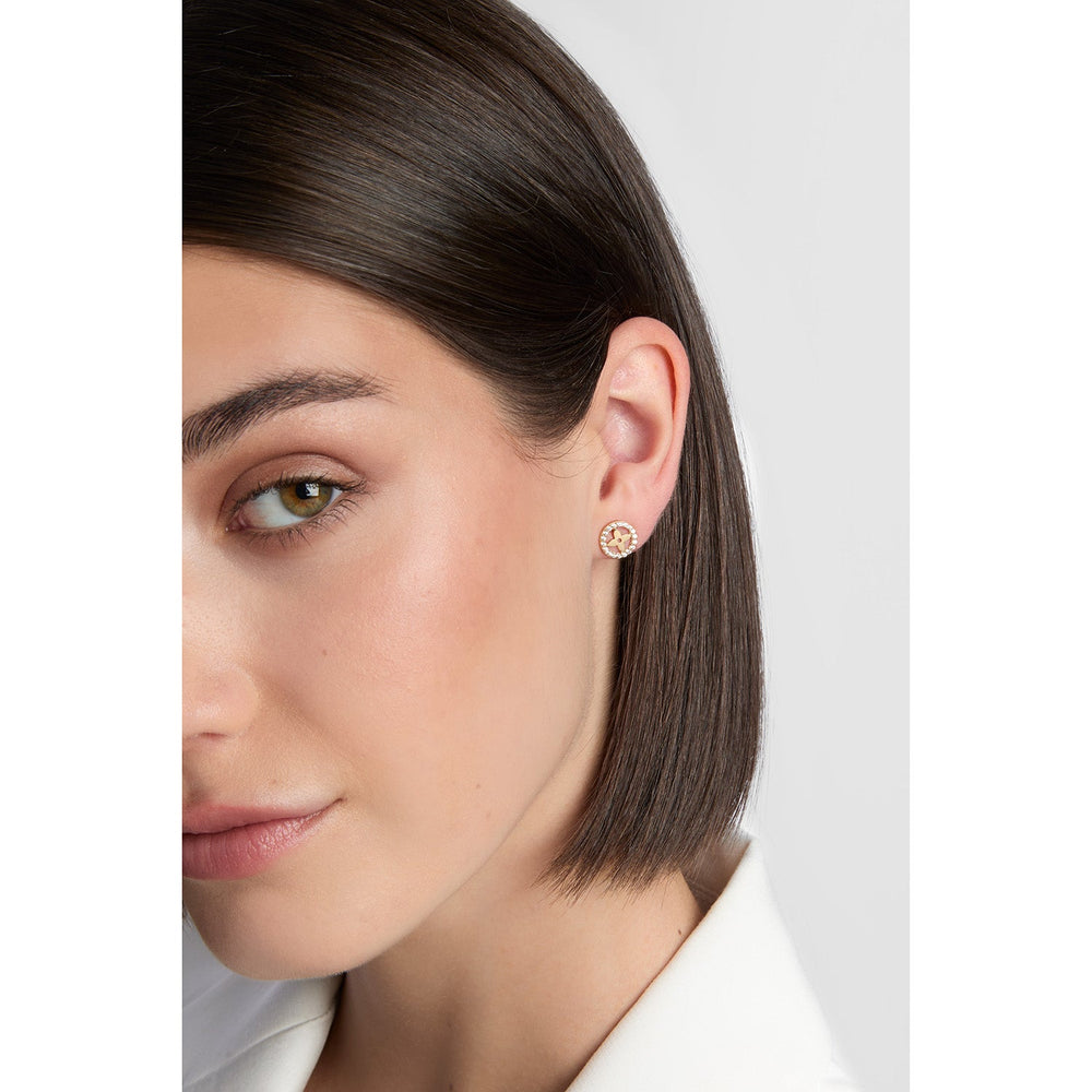 model wearing gold circle flower earrings