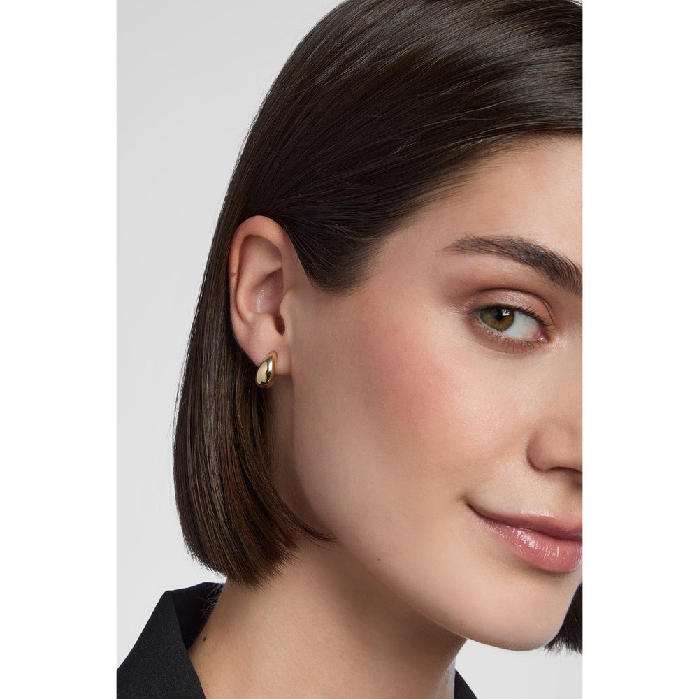 model wearing gold balbous earrings