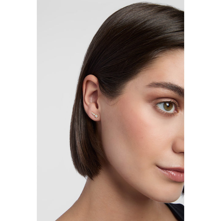 model wearing gold graduated earrings